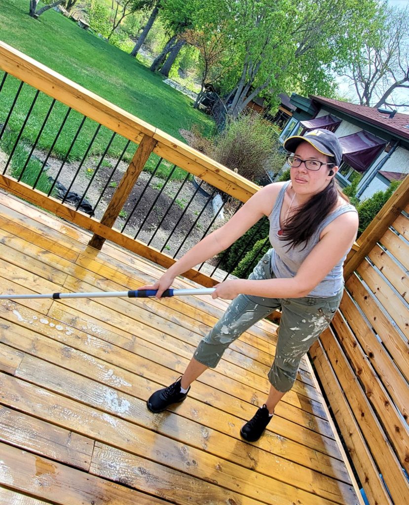 Woman cleans deck. 