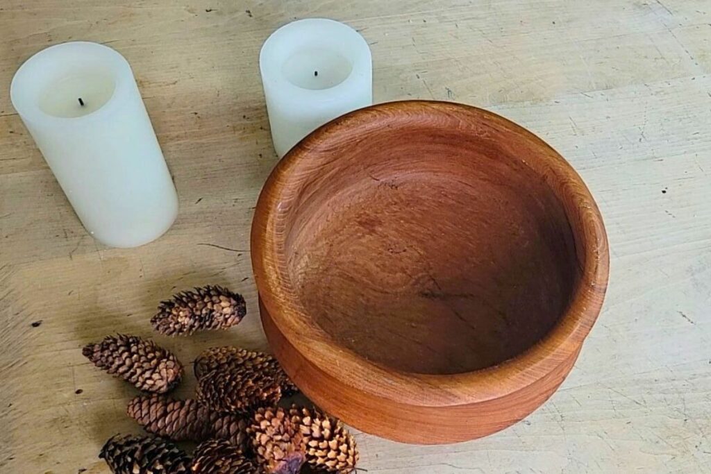 Wood bowl, candles and pinecones